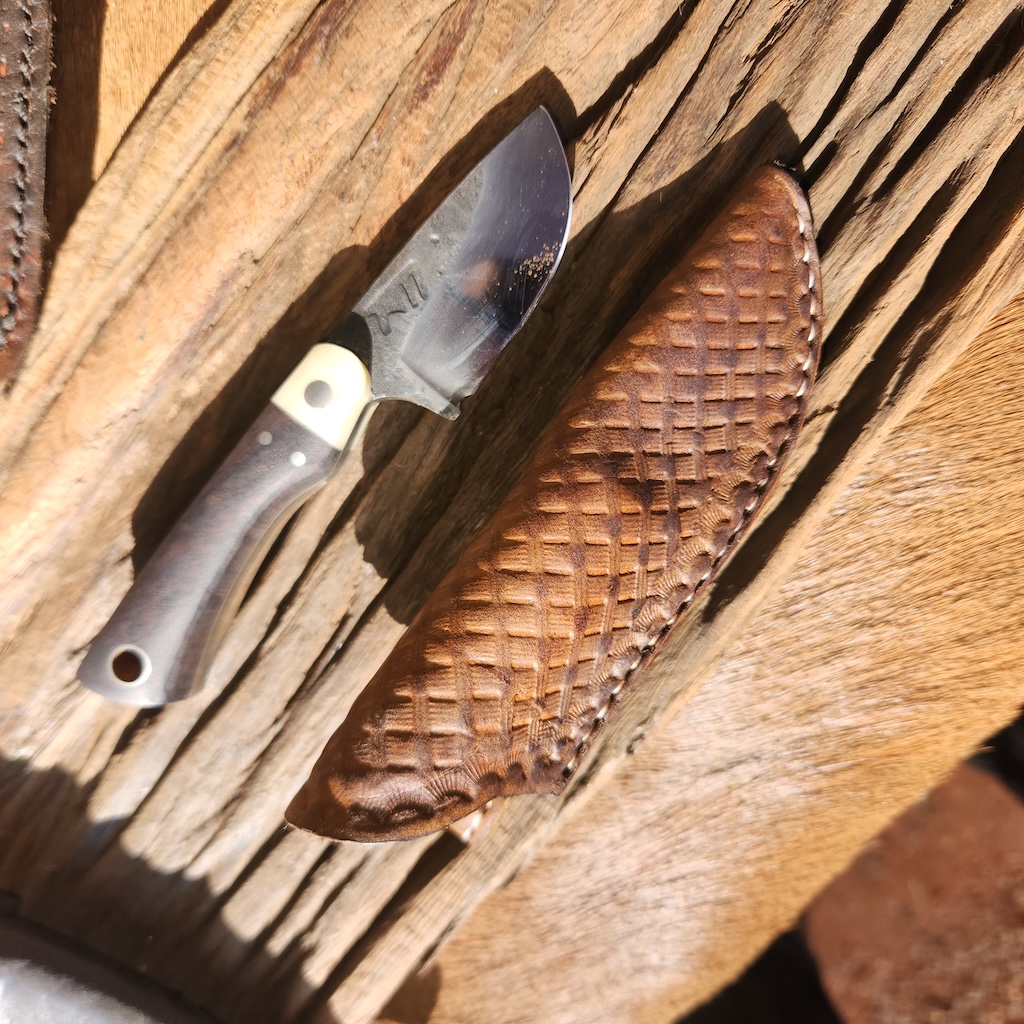 Small handcrafted knife with leather cover