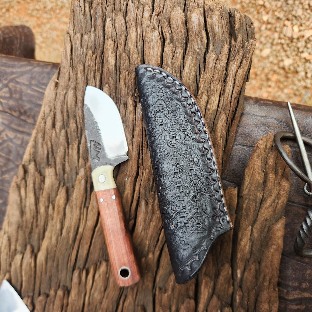 Small handcrafted knife with leather sheath