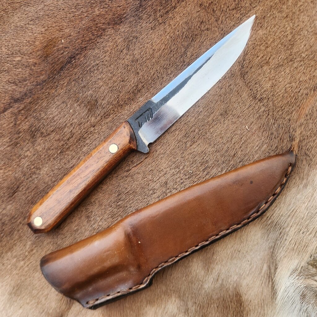 Handcrafted knife with wooden handle and leather cover