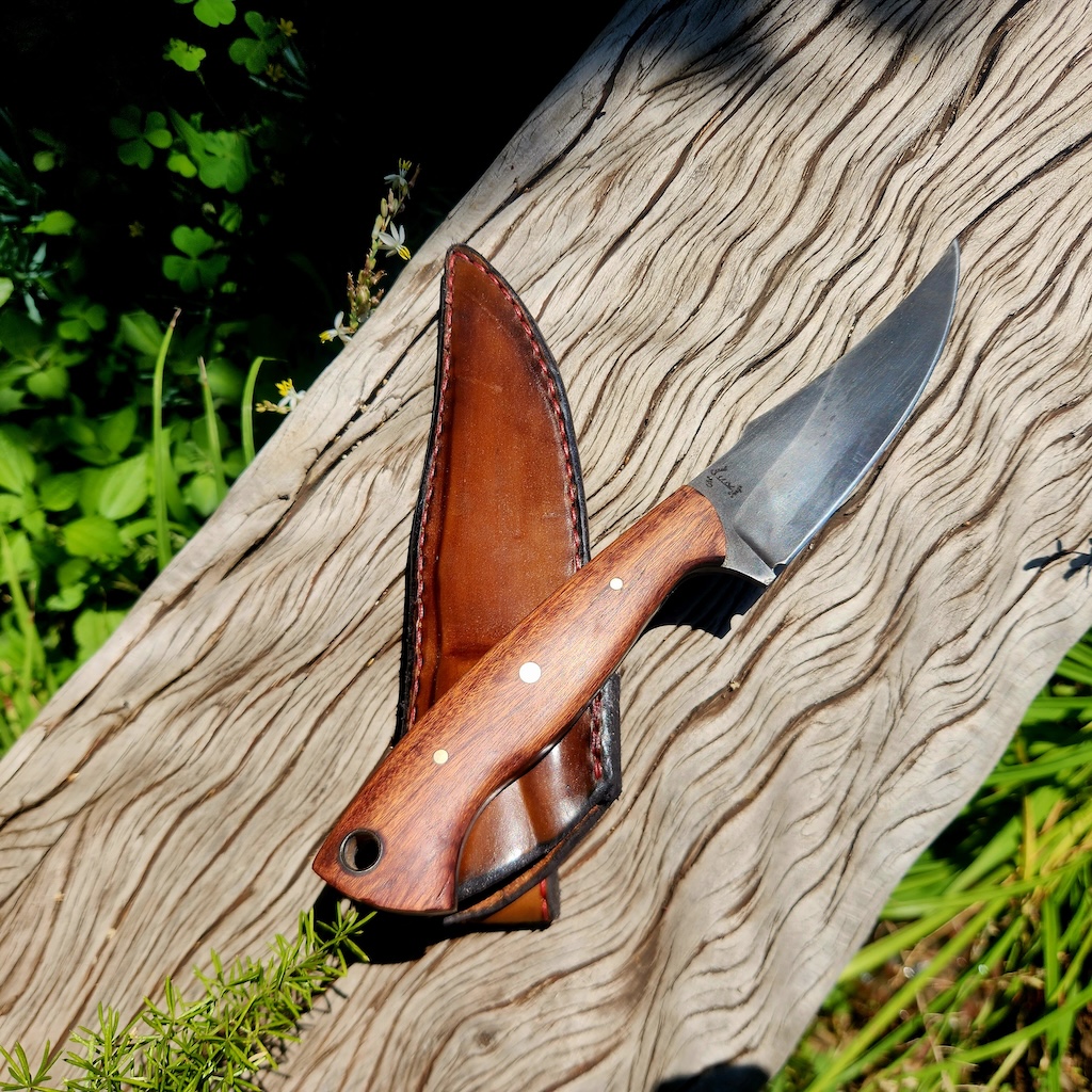 Handcrafted knife with leather sleeve